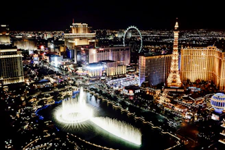 Iconic landmarks from famous world cities illuminated at night.