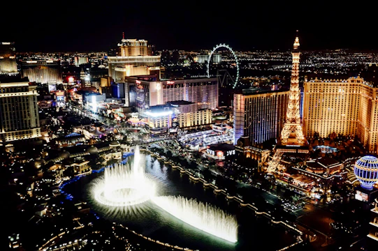 Iconic landmarks from famous world cities illuminated at night.