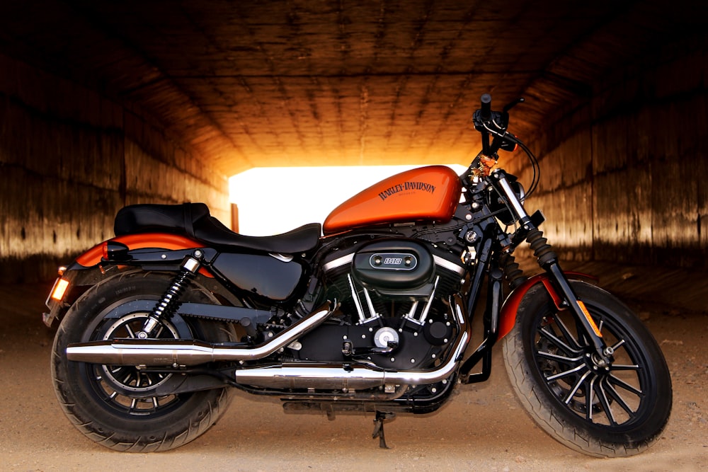 orange and black bobble motorcycle in tunnel