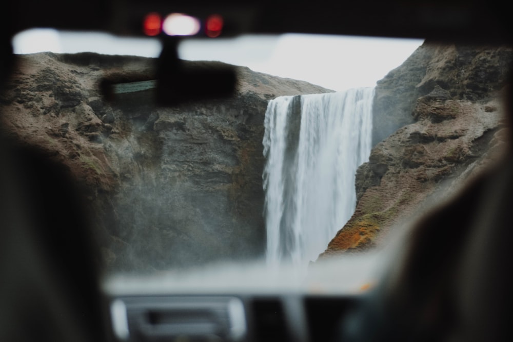 vehicle view of waterfalls during daytime