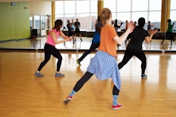 women dancing near mirror