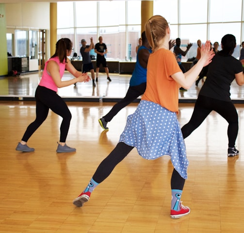 women dancing near mirror