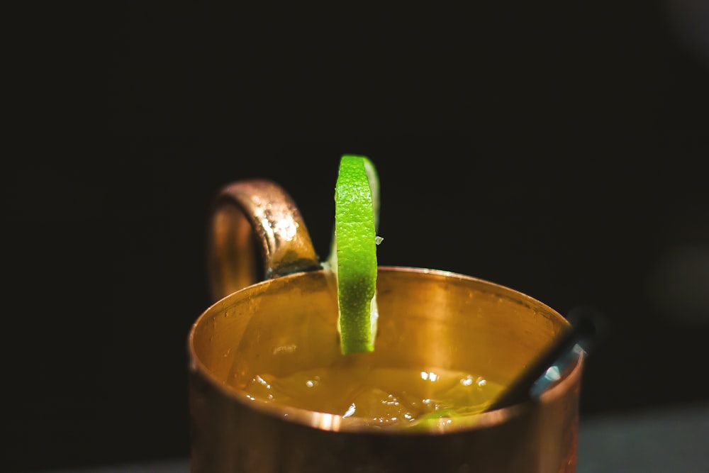 brass-colored cup with lemon