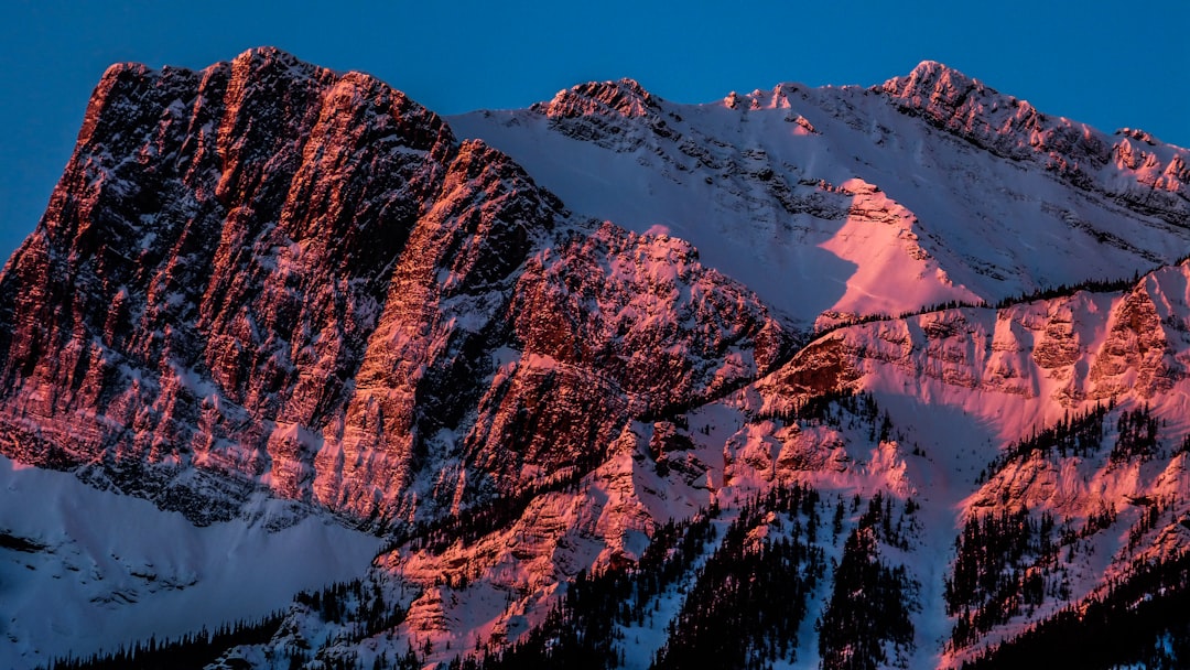 brown mountain covered by snow at daytime