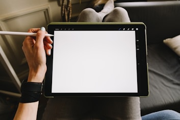 man holding iPad wand Apple Pencil