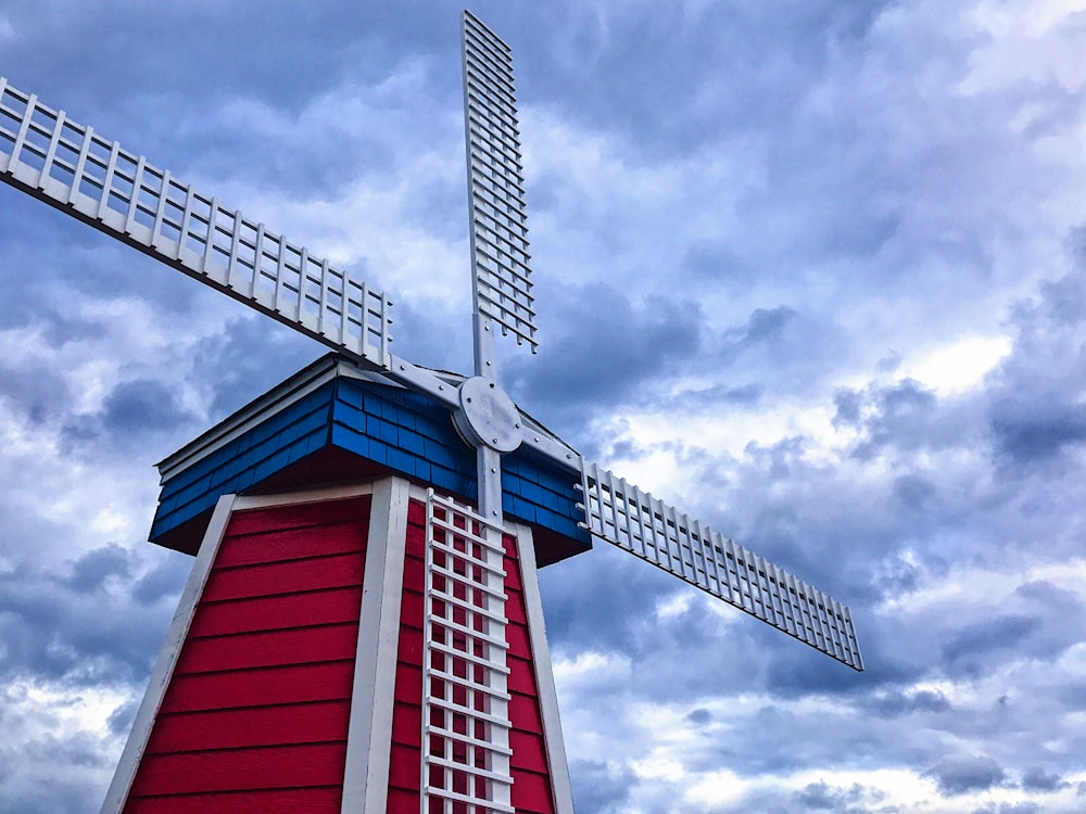 white and red barn house with wind mill