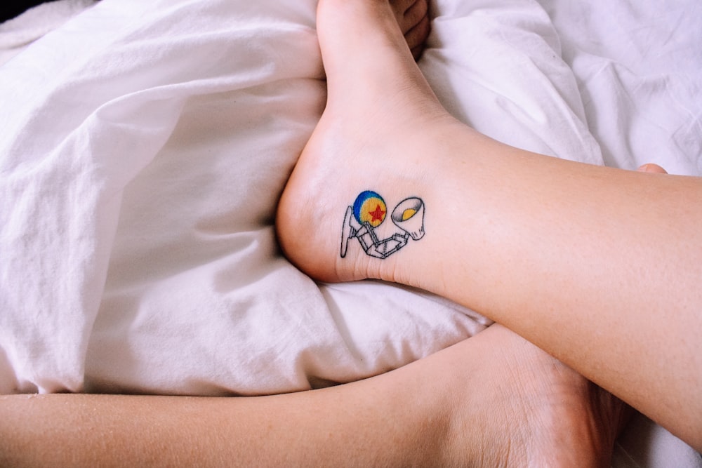 person feet on white textile