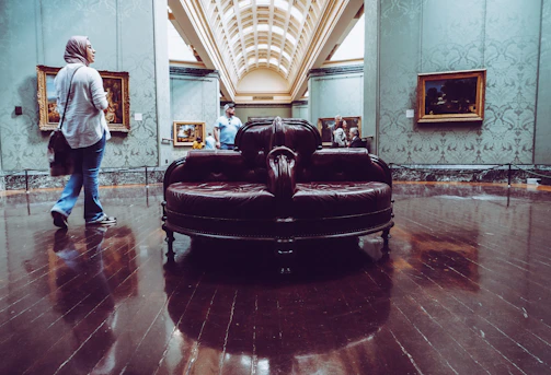 Wide shot of the gallery’s living room space with artworks arranged thoughtfully around seating areas.