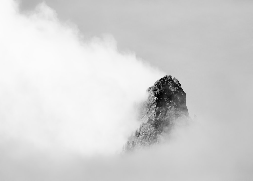 mountain covered with clouds grayscale photography