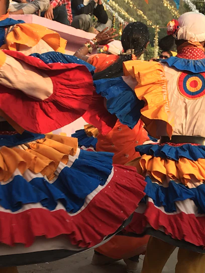 Colorful dancers in traditional Andean costumes celebrating the vibrant Ayacucho carnival with lively movement.