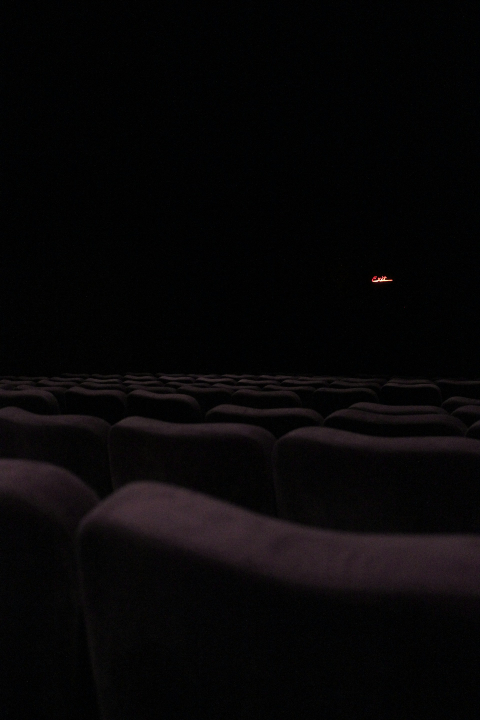 a dark room with rows of seats in it