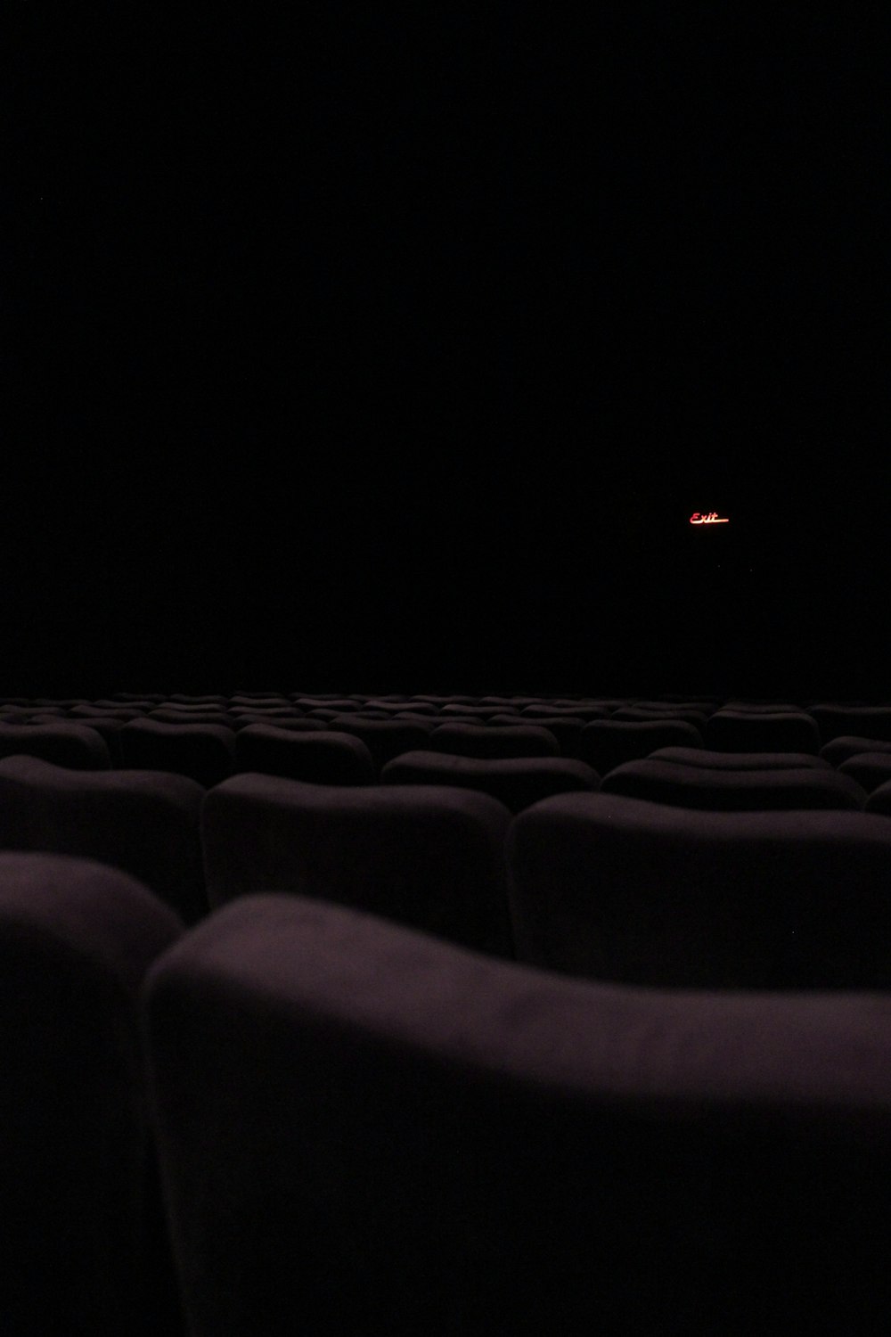 a dark room with rows of seats in it