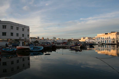 A serene early morning shot of electric boats gliding silently over calm Mediterranean waters.