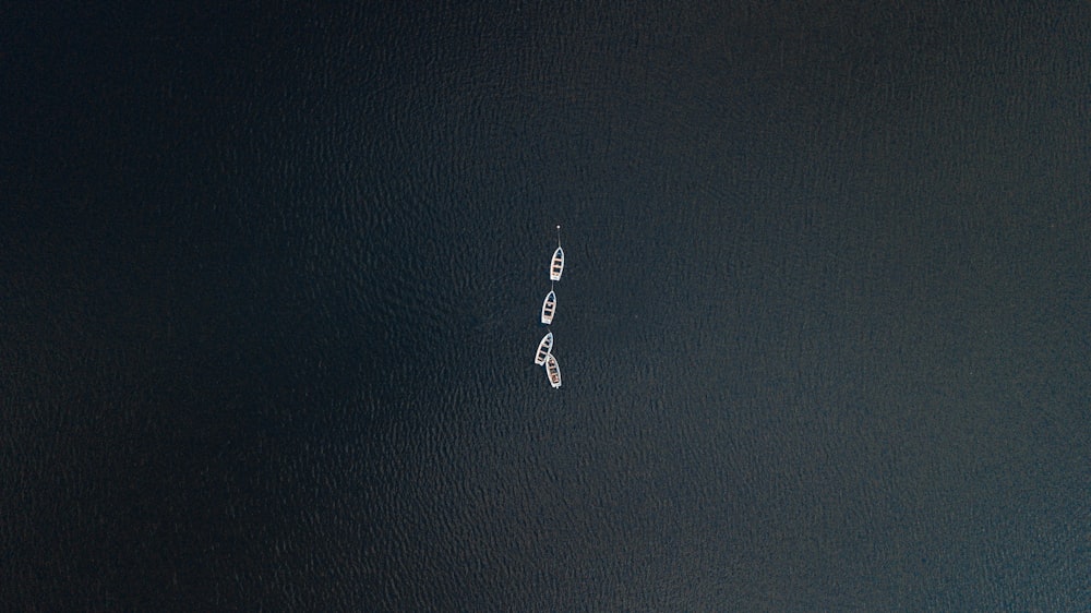 an aerial view of a boat in a body of water