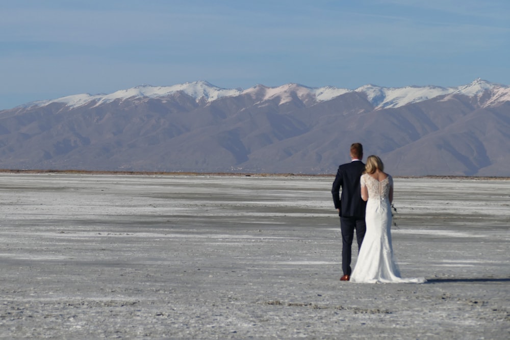 newly wed couple walking viewing mountain