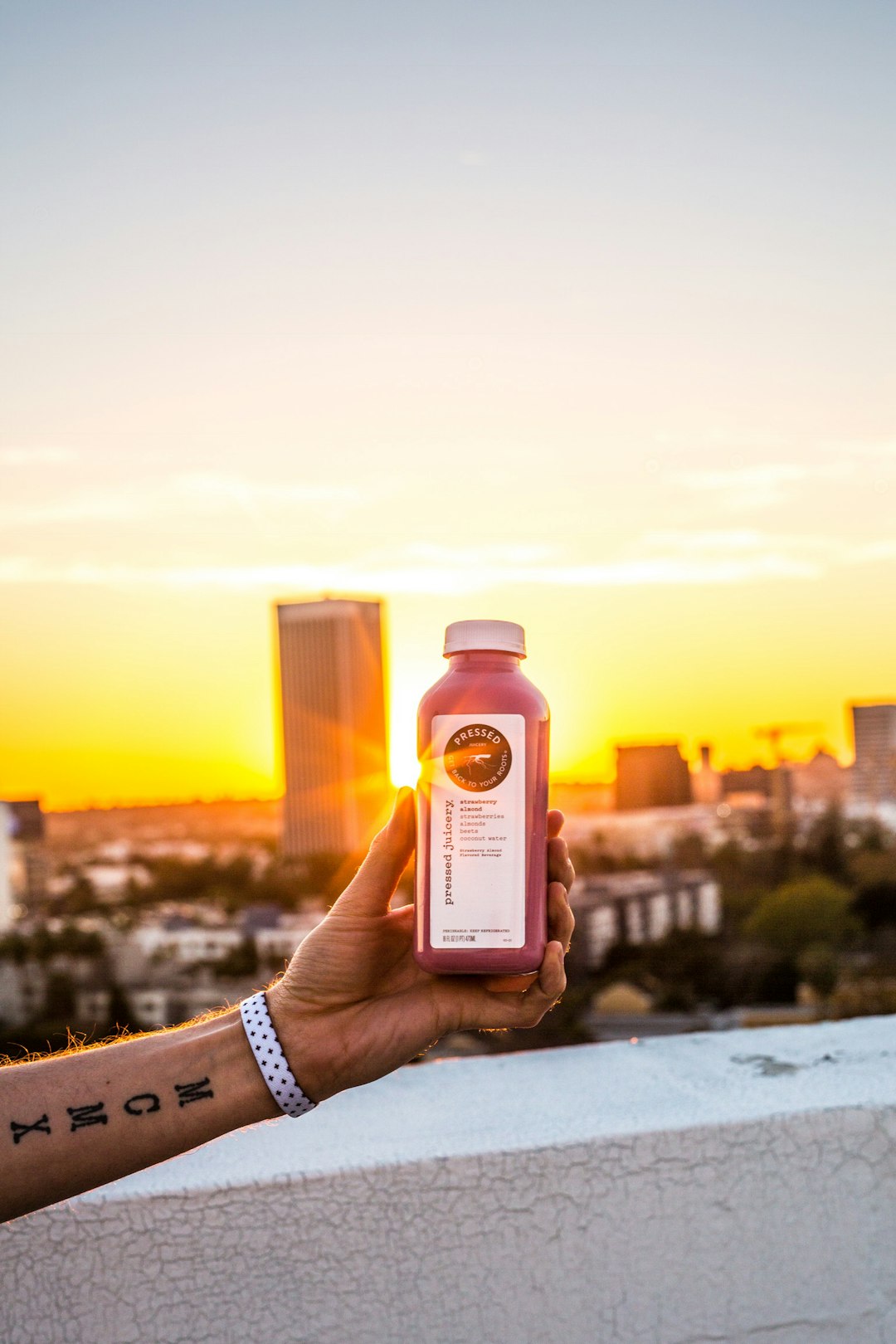 person holding pink bottle