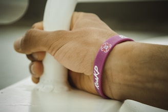Athlete gripping a basketball while wearing slip-resistant wristbands during a game