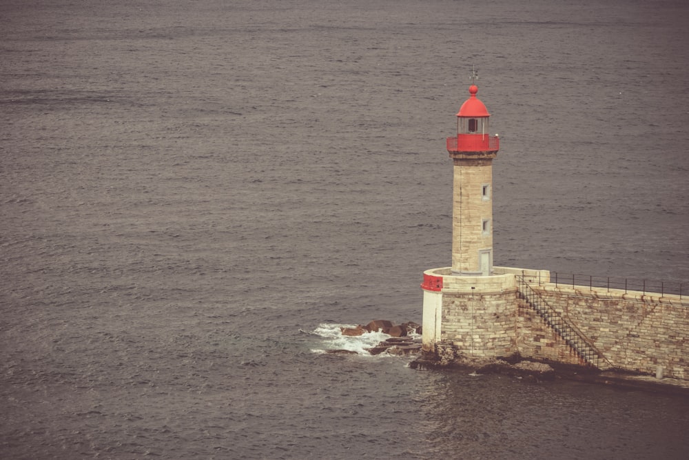 white lighthouse near ocean water during daytime