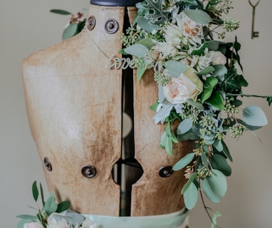 brown torso mannequin surrounded by plant