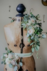 brown torso mannequin surrounded by plant