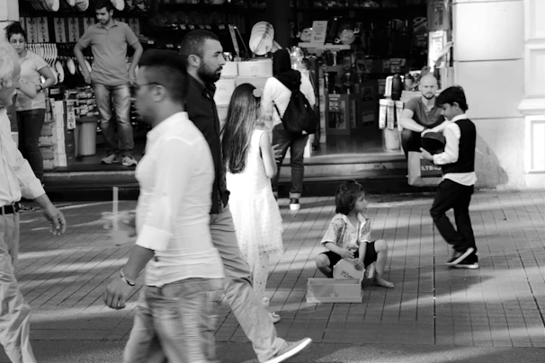 Dynamic ground-level capture of a street scene with children playing and daily life unfolding.