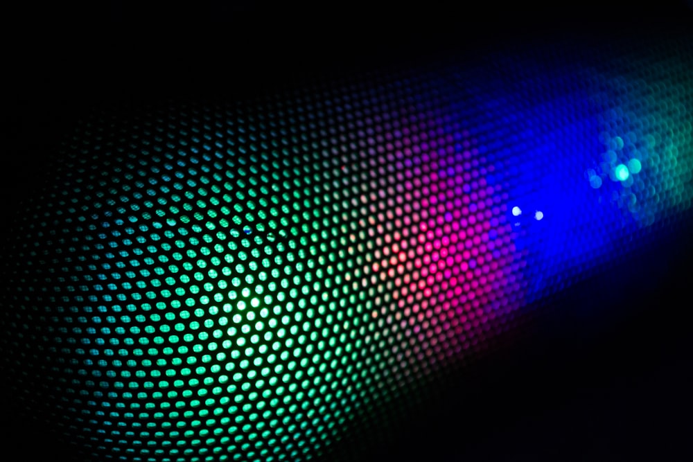 a close up of a colorful light in the dark