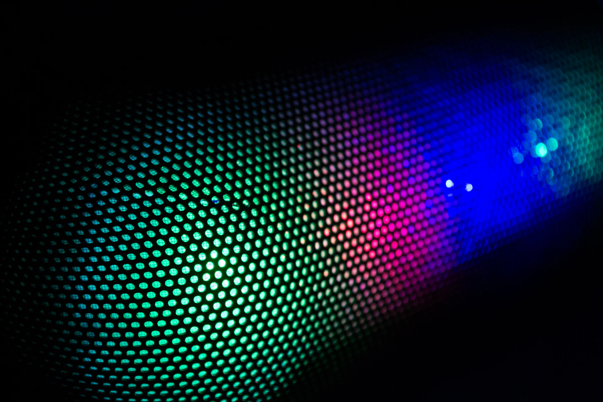 a close up of a colorful light in the dark