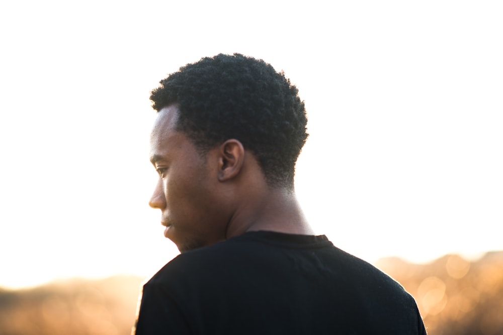 man wearing black crew-neck t-shirt