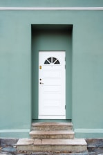 green and white concrete house during daytime photo