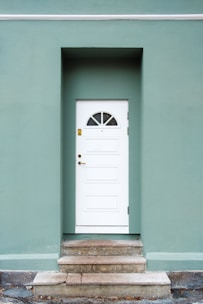 green and white concrete house during daytime photo