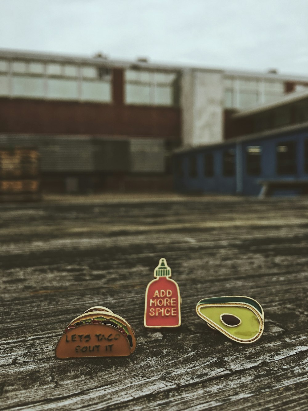 three taco, spice bottle and avocado ornaments on brown wood platform photo