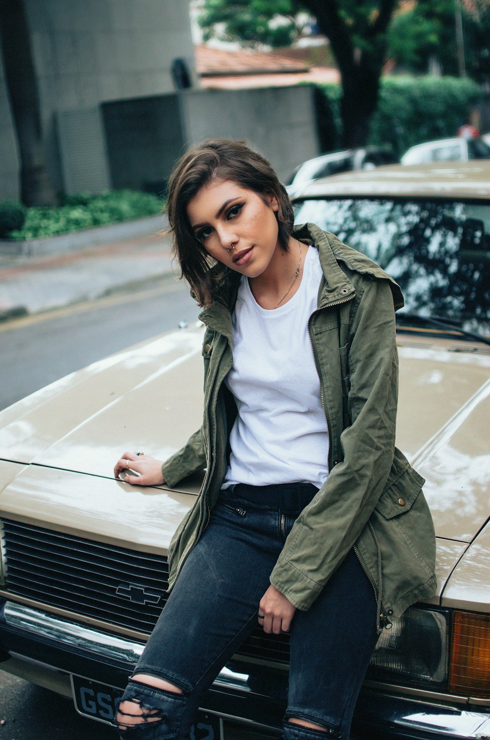 shallow focus photography of woman sitting on car