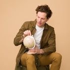 man holding globe while on sit