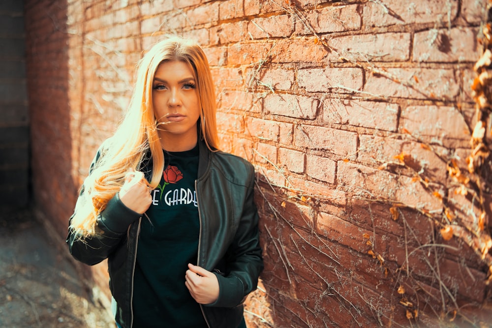 woman leaning on wall for photo shoot