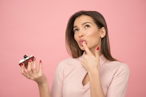 woman holding cake in bakery