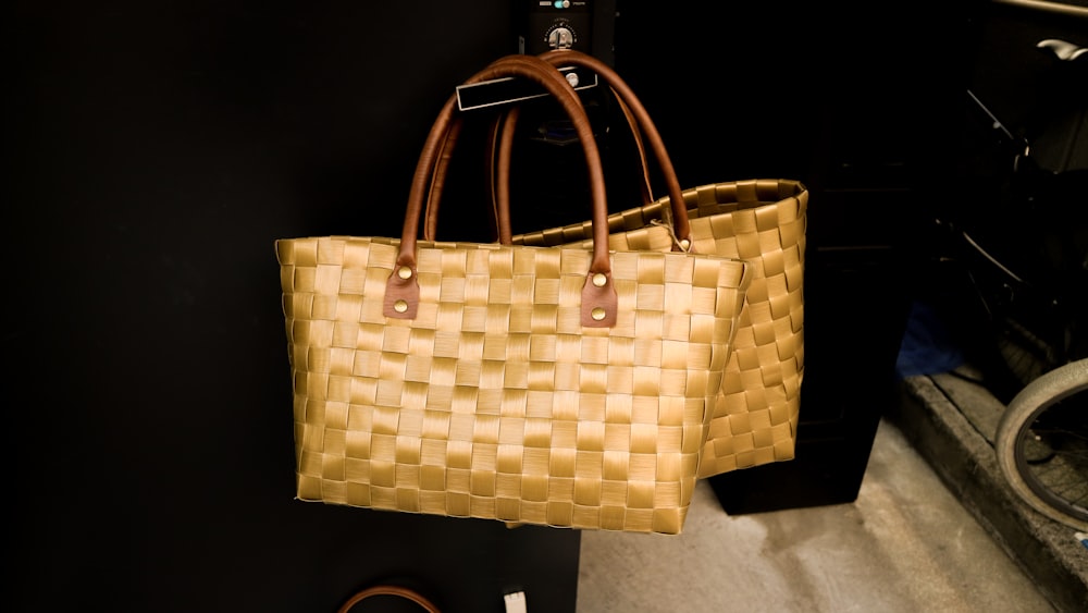 two brown woven tote bags