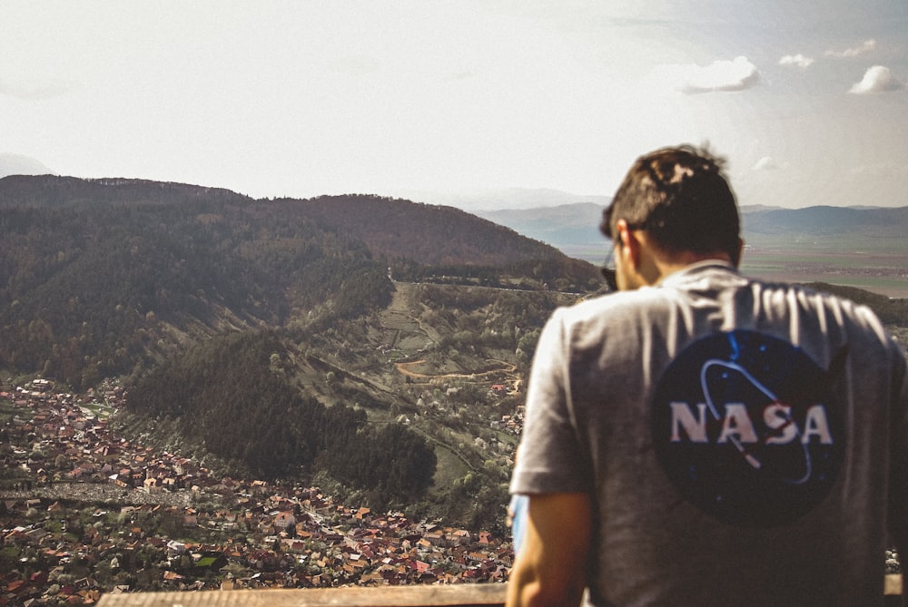 man facing city and mountain