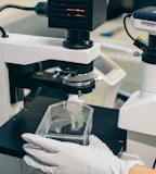 person holding black and white microscope