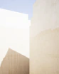 a man riding a skateboard down a street next to tall buildings