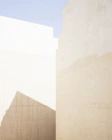 a man riding a skateboard down a street next to tall buildings