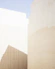 a man riding a skateboard down a street next to tall buildings