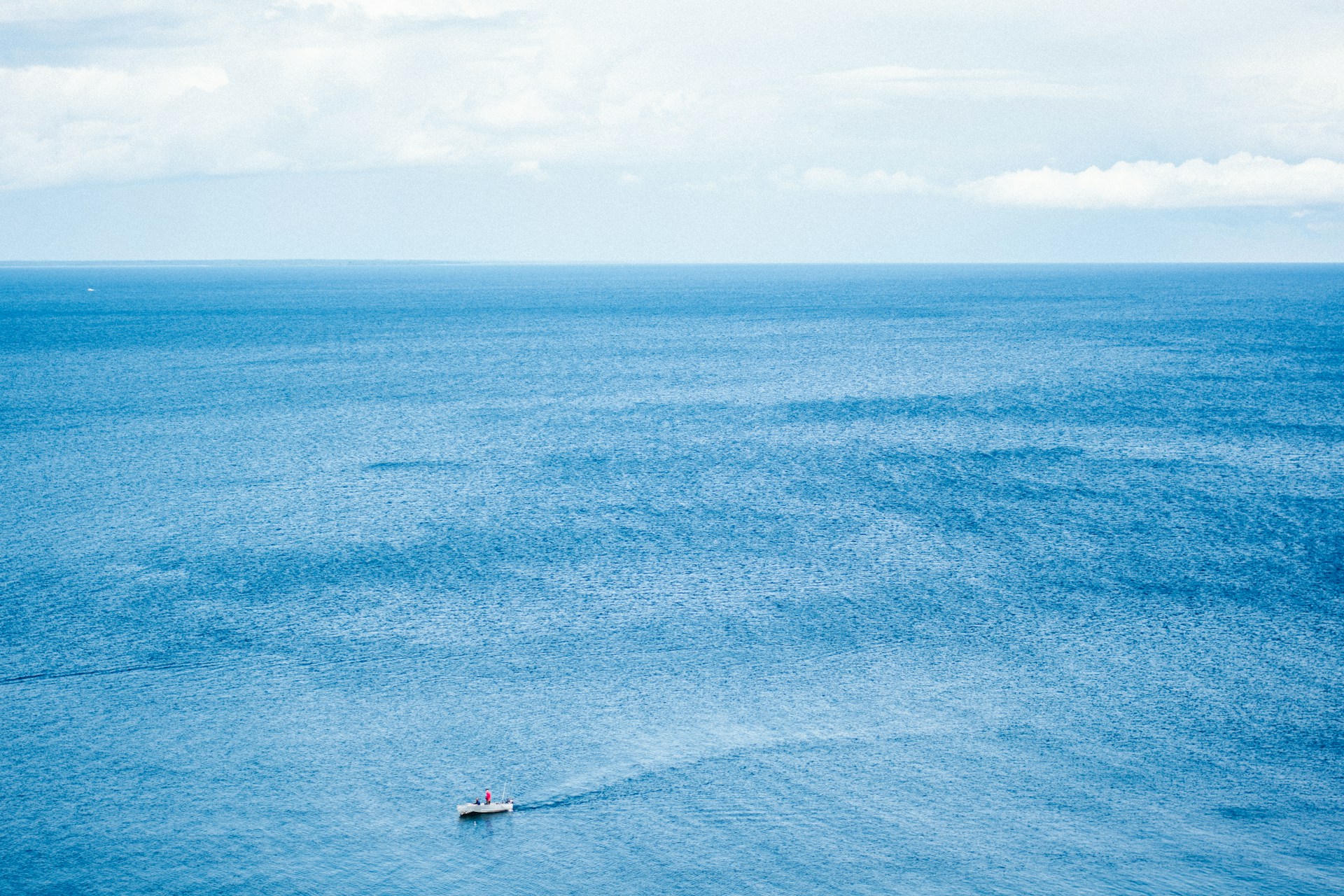 aerial photo of motor boat surrounded of body of water during daytime