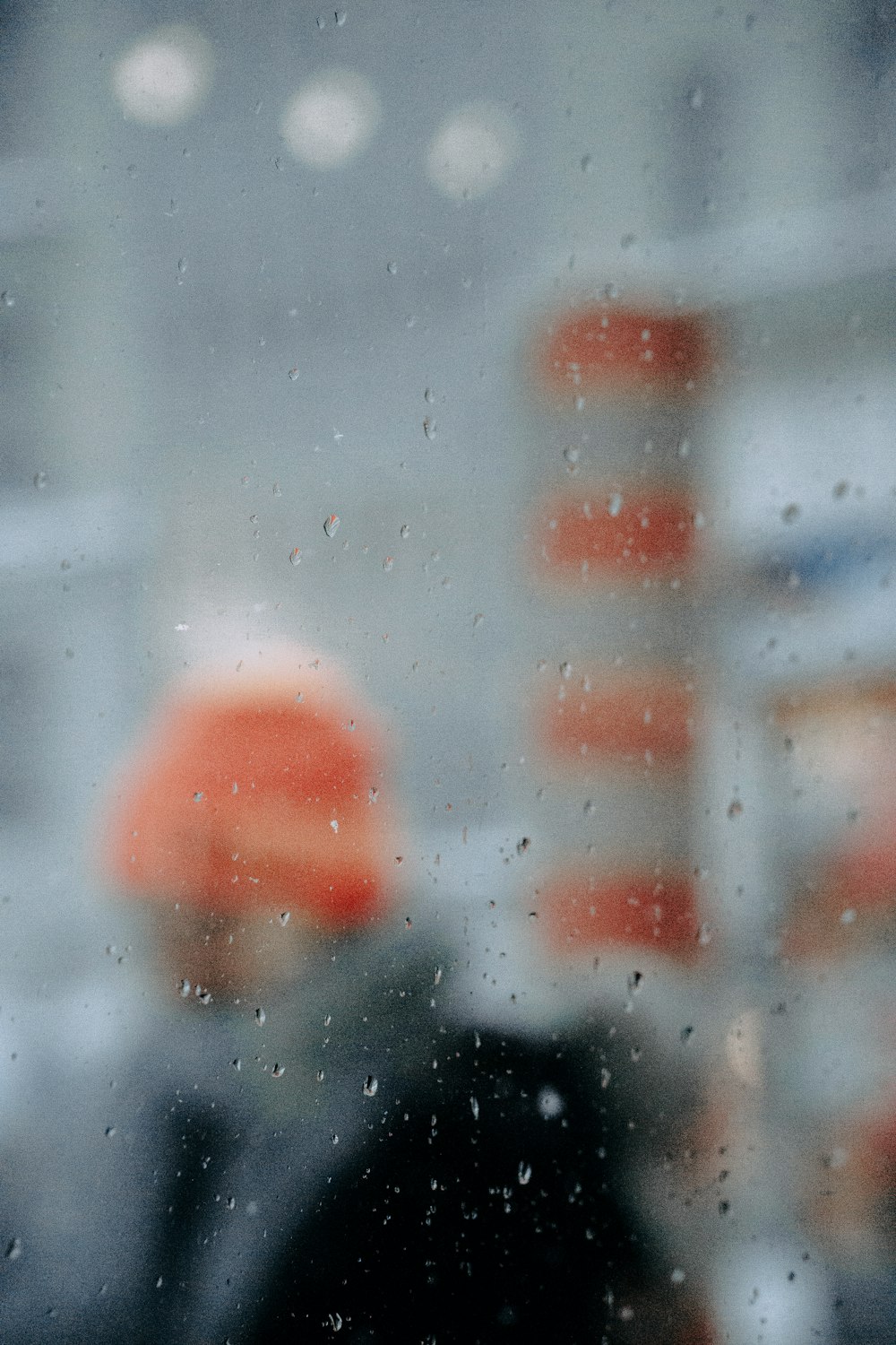 a blurry photo of a person standing in the rain