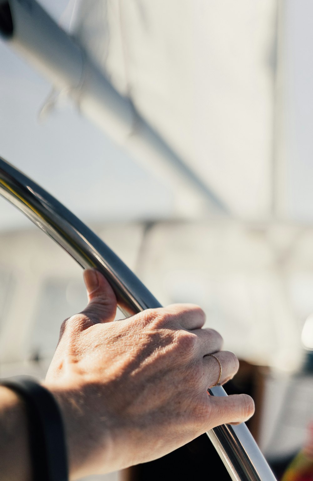 person holding gray metal tube