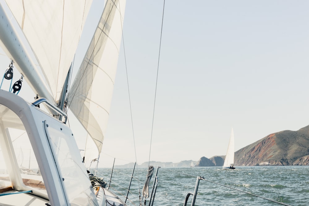 white yacht on body of water