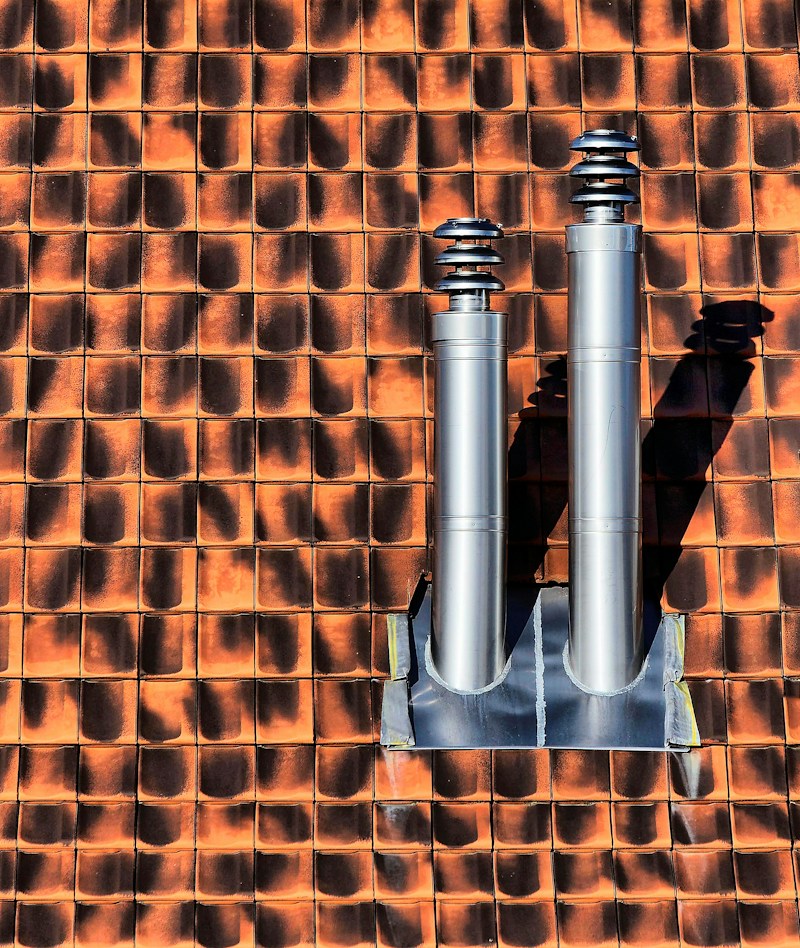 Roof pipe boot flashing sealed around a plumbing vent pipe