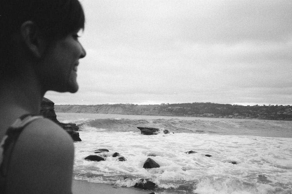 smiling woman standing on front onf seashore