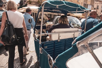 woman riding on auto rickshaw during daytime