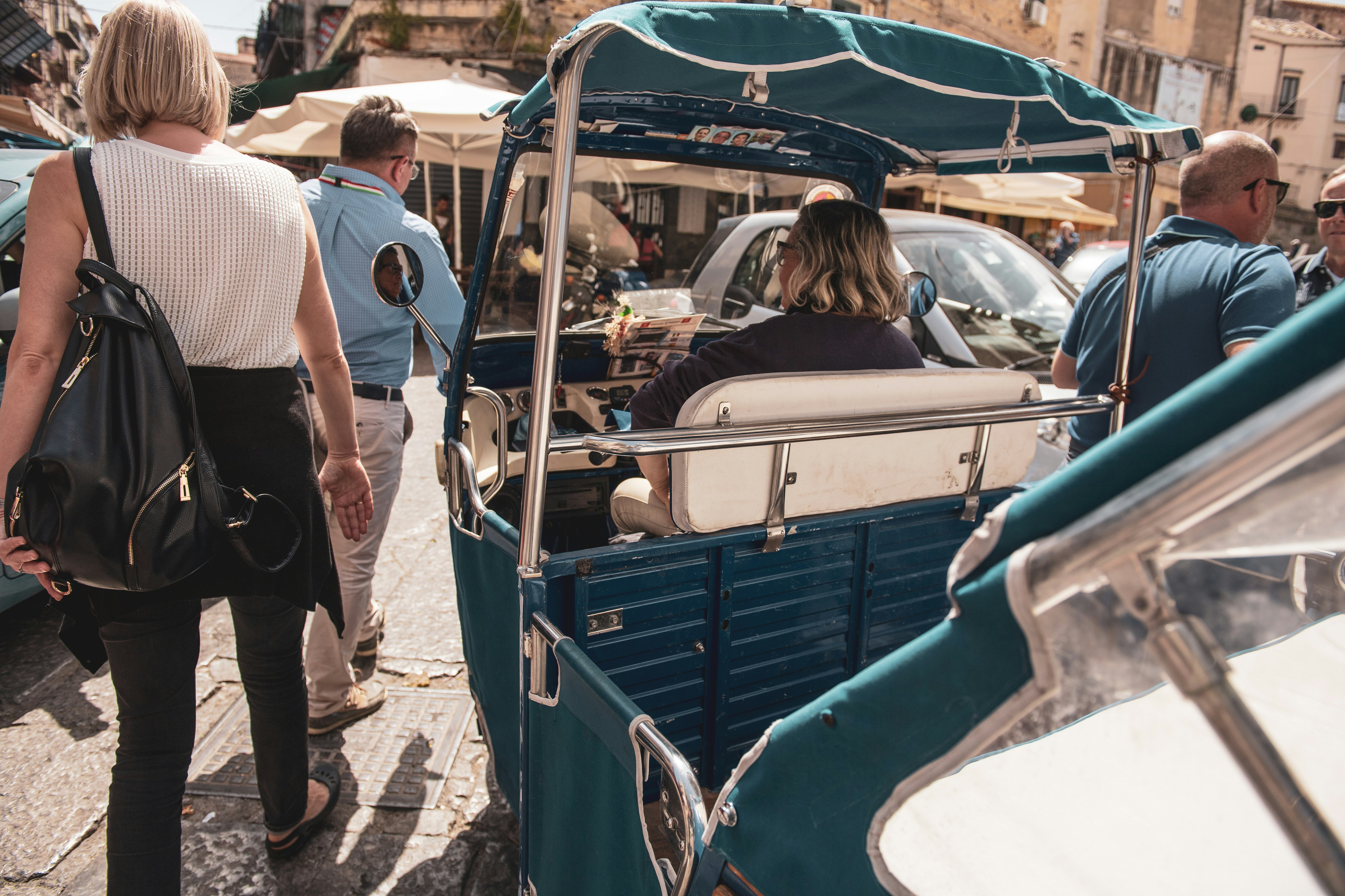 woman riding on auto rickshaw during daytime