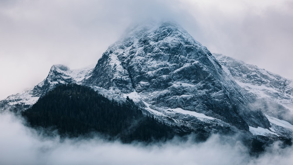 gray mountain covered in snow at daytime